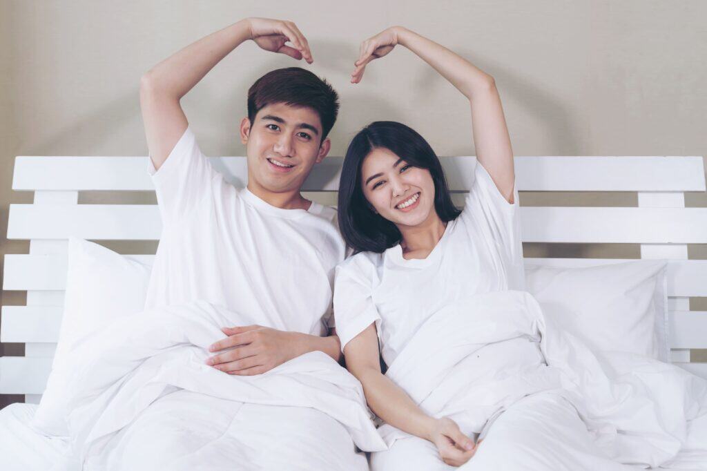 happily-young-couple-raise-up-arms-make-heart-shape
