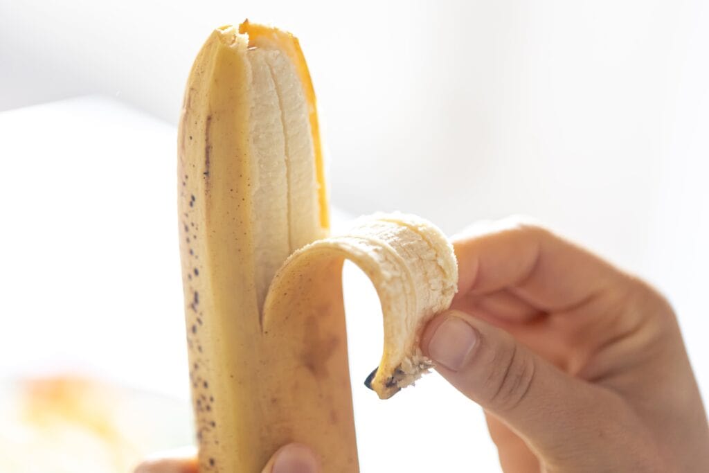 woman-peels-ripe-banana-closeup