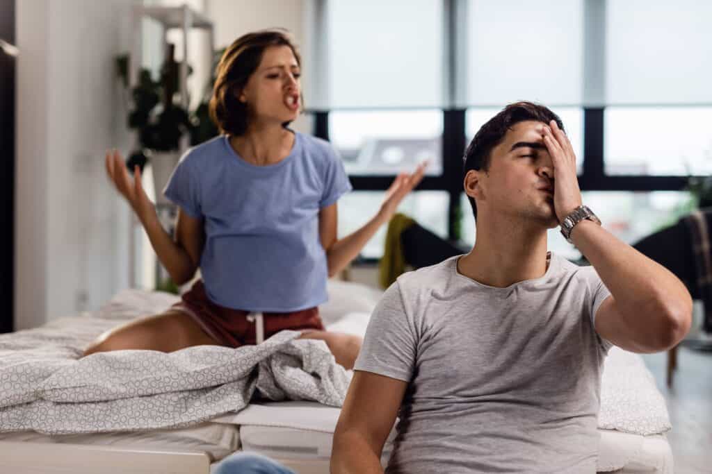 young-man-feeling-stressed-out-having-headache-while-his-girlfriend-is-arguing-with-him-bedroom 無性婚姻
